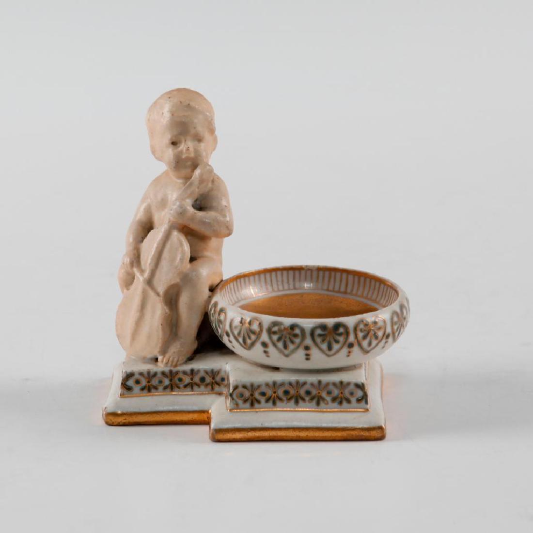 DOULTON LAMBETH OPEN SALT G. TINWORTH BOY & BASS FIDDLE: A rare George Tinworth piece with gilt center and to base. Tinworth modeled a number of unique open salts with childen playing a variety of musical instruments. Porcelain base, child with matte finish