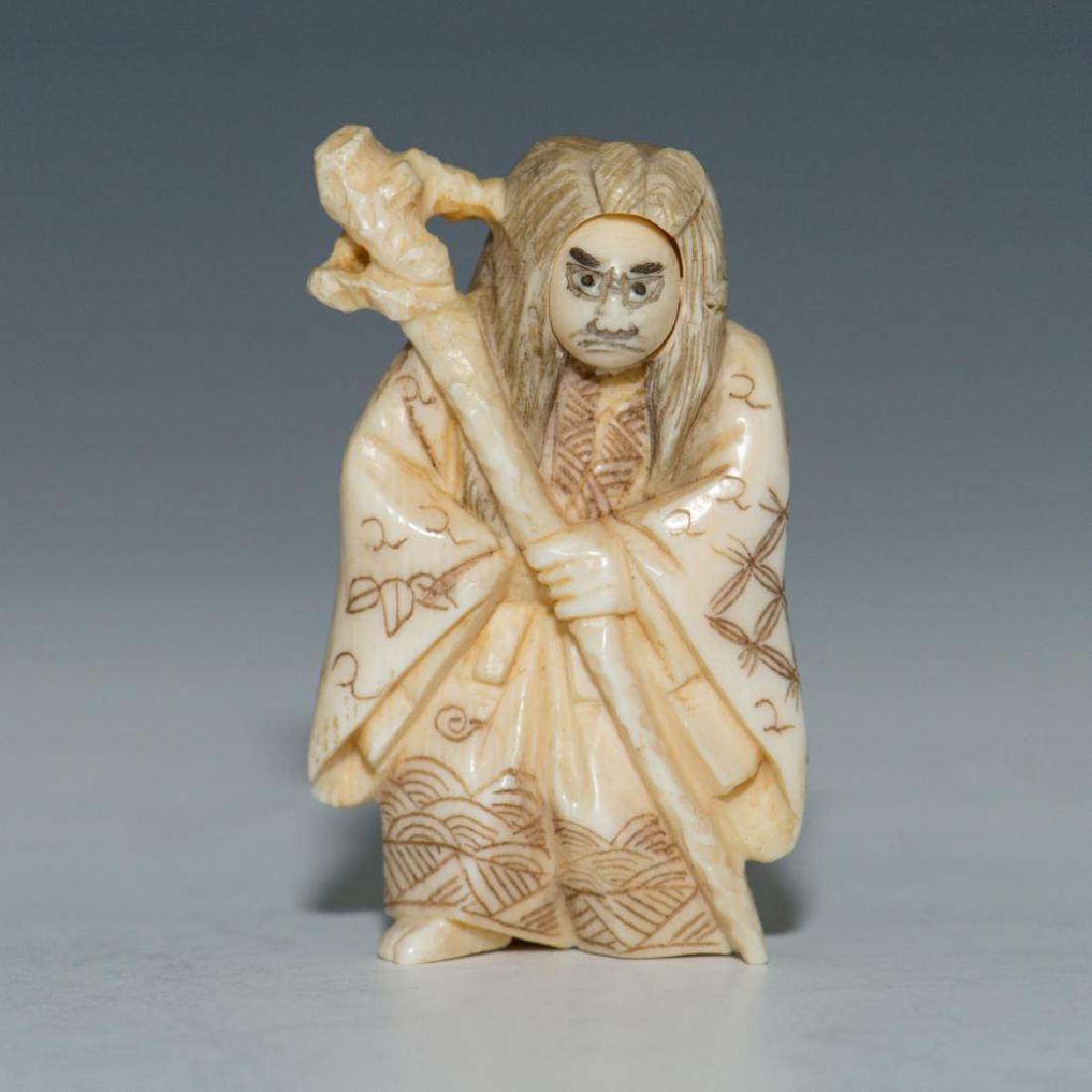 ANTIQUE CARVED BONE JAPANESE NETSUKE 2 FACE FIGURE: Netsuke carving with a rotating face with two expressions. Dimensions: 2"H Country of Origin: Japan