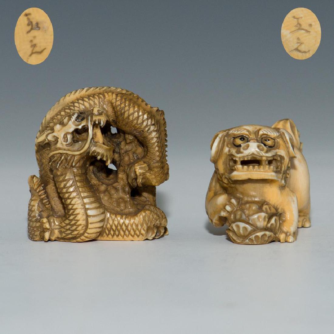 GROUP OF 2 ANTIQUE JAPANESE CARVED BONE NETSUKES: Set of 2 netsuke carvings: Foo Dog and a Coiled Dragon. Both signed on the bottom. Dimensions: Tallest 2.5" Country of Origin: Japan
