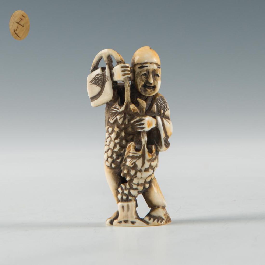 ANTIQUE JAPANESE CARVED BONE NETSUKE MAN GRAPES SELLER: Netsuke carving of a man with giant grapes. Inscribed signature on the bottom. Dimensions: 2.25"H Country of Origin: Japan