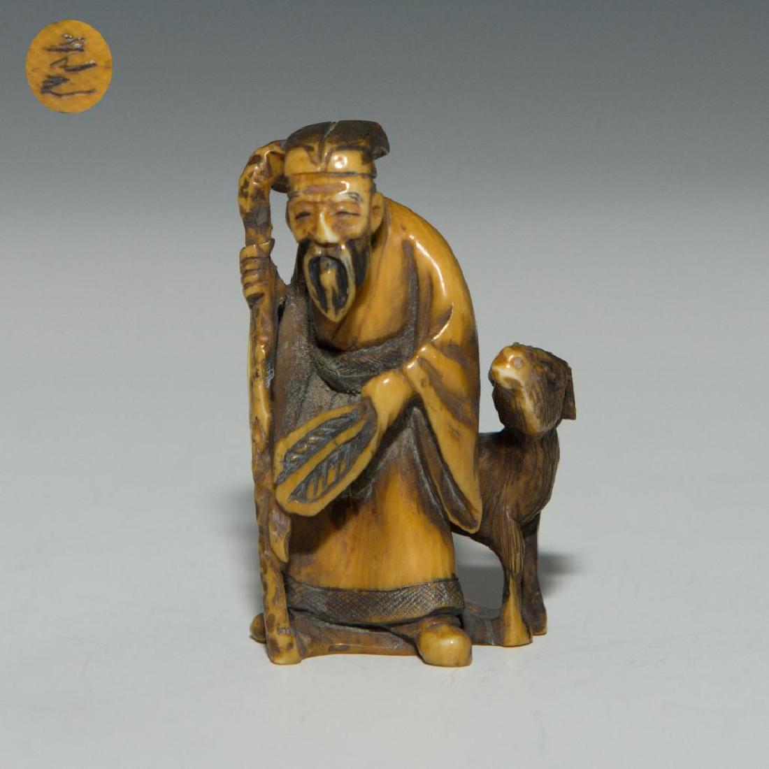 ANTIQUE JAPANESE CARVED BONE NETSUKE MAN WITH A DEER: Netsuke carving figure of a man with a deer. Inscribed signature on the bottom. Dimensions: 2'H Country of Origin: Japan