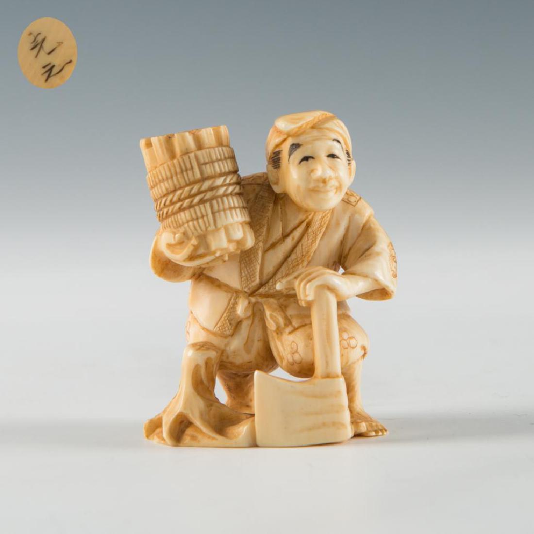 ANTIQUE JAPANESE CARVED BONE NETSUKE MAN WOOD CUTTER: Netsuke carving figure of a man with wood and an axe. Inscribed signature on the bottom. Dimensions: 2"H Country of Origin: Japan