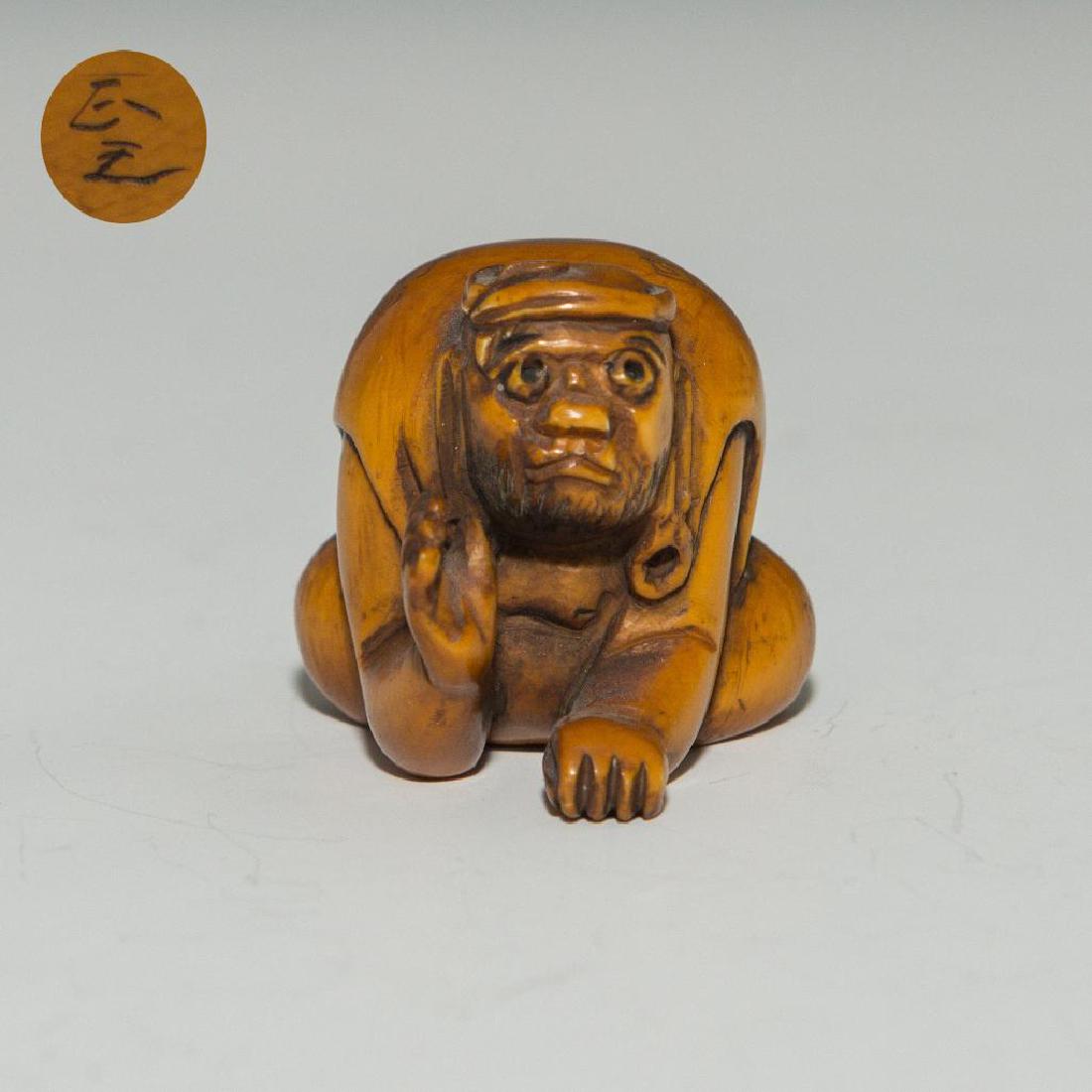 ANTIQUE JAPANESE CARVED BONE NETSUKE BLIND BEGGER: Netsuke carving figure of a blind beggar. Inscribed signature on the bottom. Dimensions: 1.5"H Country of Origin: Japan
