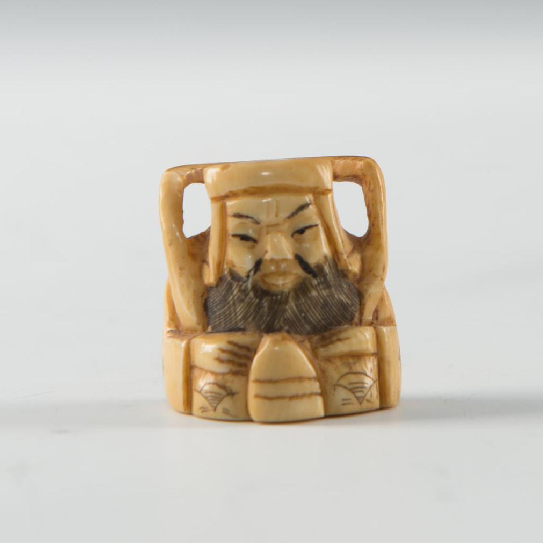 ANTIQUE JAPANESE CARVED BONE NETSUKE WISEMAN: Netsuke carving two handled figure of a man. Dimensions: 1"H x 1"L Country of Origin: Japan