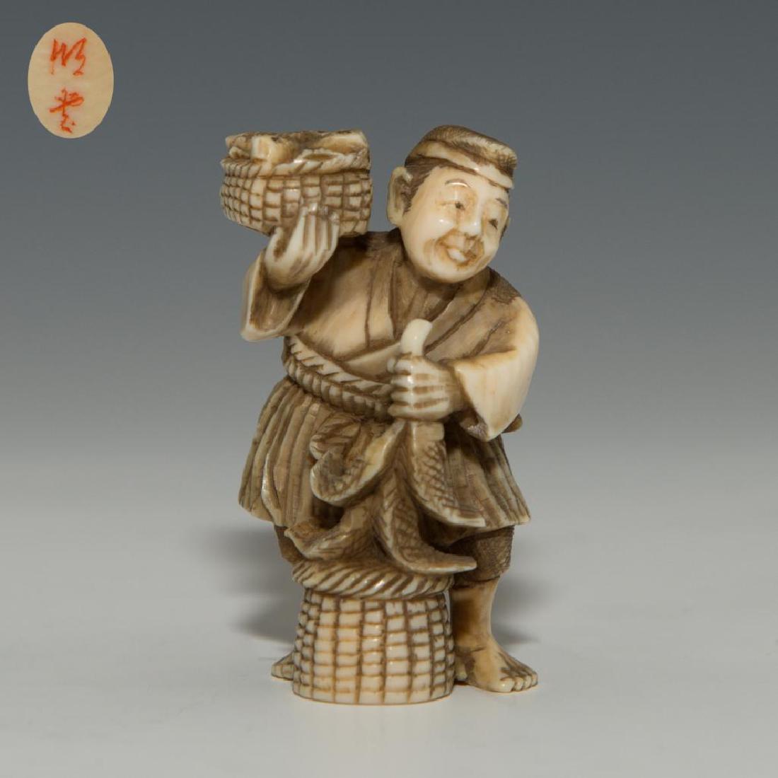ANTIQUE JAPANESE CARVED BONE NETSUKE FISH SELLER: Netsuke carving figure of a man selling fish. Signed on the bottom. Dimensions: 2"H Country of Origin: Japan