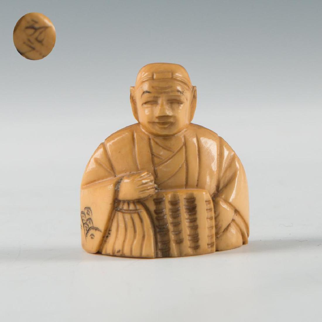 ANTIQUE JAPANESE CARVED BONE NETSUKE MAN: Netsuke carving as a figure of a man. Inscribed signature on the bottom. Dimensions: 1.5"H Country of Origin: Japan