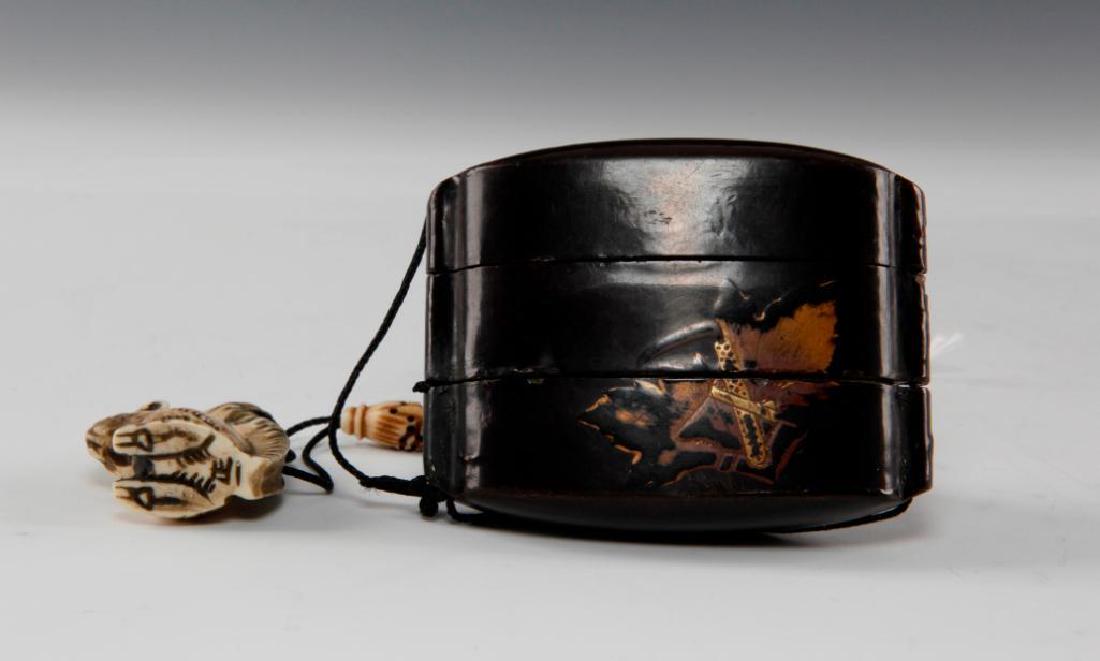 ANTIQUE JAPANESE LACQUER INRO WITH CARVED BONE NETSUKE: Three section lacquer wood inro with squirrel and ojime bead. Inro depicts bull on one side and leaf on the other. Dimensions: inro 3"L x 2"H netsuke 1.75"H Country of Origin: Japan