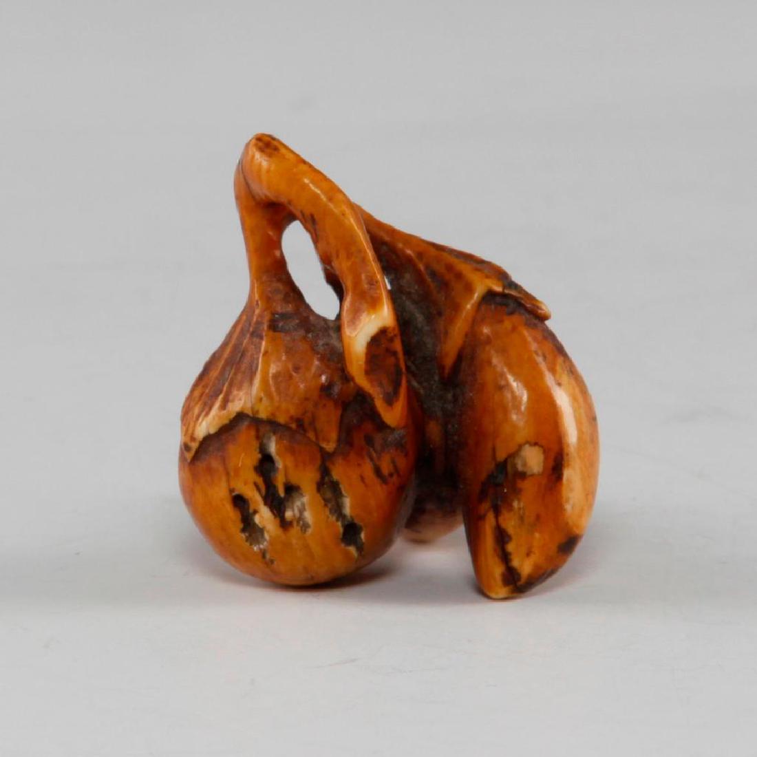 ANTIQUE JAPANESE CARVED BONE NETSUKE EGGPLANT: Netsuke carving in shape of three eggplants. Dimensions: 1.5"L Country of Origin: Japan