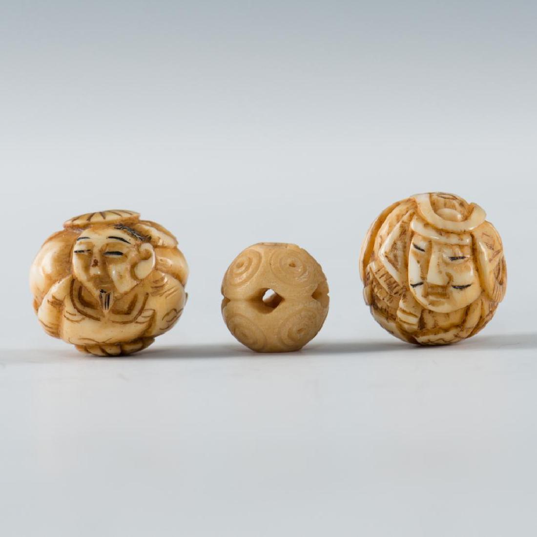 GROUP OF 3 ANTIQUE CARVED BONE BEADS: Set of 3 finely carved beads including 2 depicting faces. Dimensions: largest 0.5"D