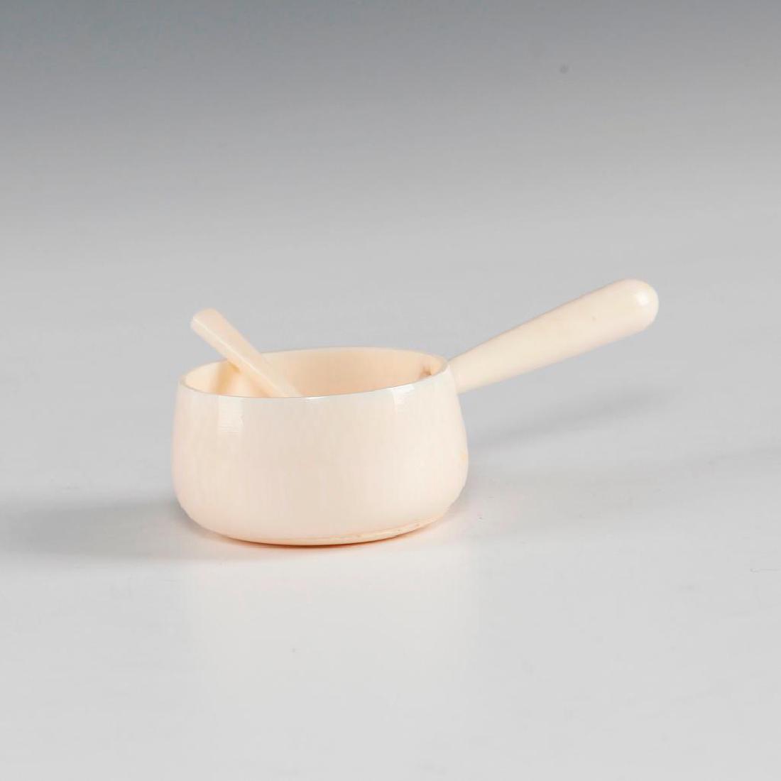 ANTIQUE CHINESE CARVED BONE MINIATURE HANDLED BOWL: Finely carved bowl / salt cellar with a shovel shaped spoon. Dimensions: about 3"L x 1"H Country of Origin: China