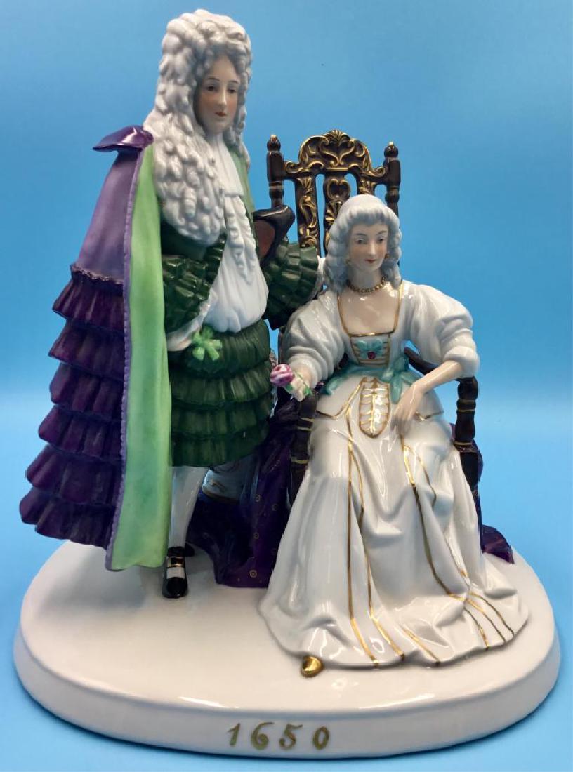 FRAUREUTH KUNSTABTEILUNG PORCELAIN GROUP FIGURINE: Fraureuth Kunstabteilung Large Figure. Depicting a Stuart Era nobleman in courtly robes and wig, standing next to a seated noblewoman. Dimensions: 9.5"H x 9"L x 9"W Issued: Circa 1919-1926. Country of