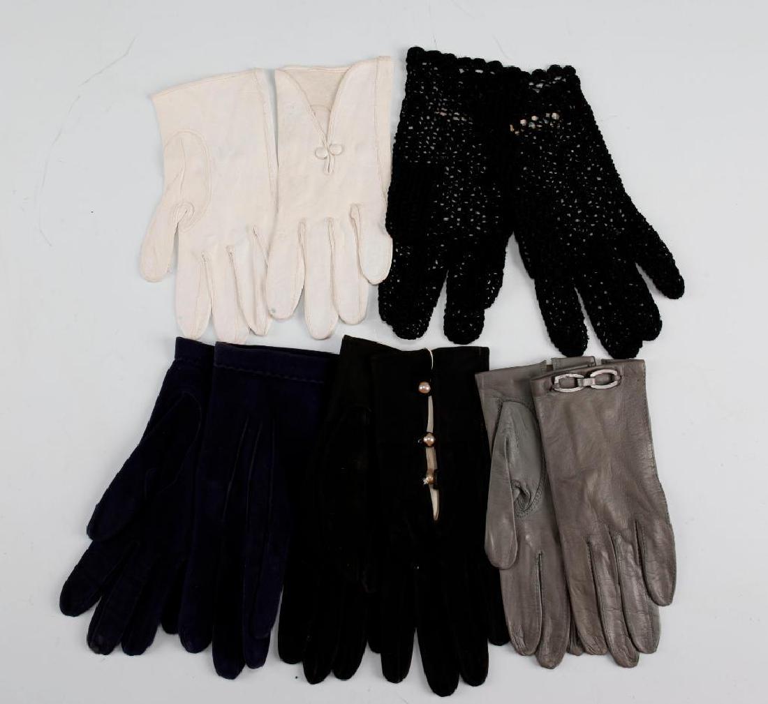 5 PAIRS OF VINTAGE ASSORTED LADIES GLOVES: 5 pairs of Vintage Ladies Gloves in assorted materials. Ladies wrist length gloves in navy blue suade, black crochet, black suade, grey leather, and white leather. Dimensions: Size 6 Country of Origin