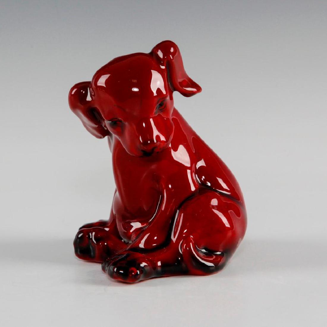 ROYAL DOULTON FLAMBE FIGURINE PUPPY: Cute figure of a seated dog. Marked on the bottom. Model HN 128. Artist: Fred Moore Issued: Circa 1913 Dimensions: 4"H Manufacturer: Royal Doulton Country of Origin: England