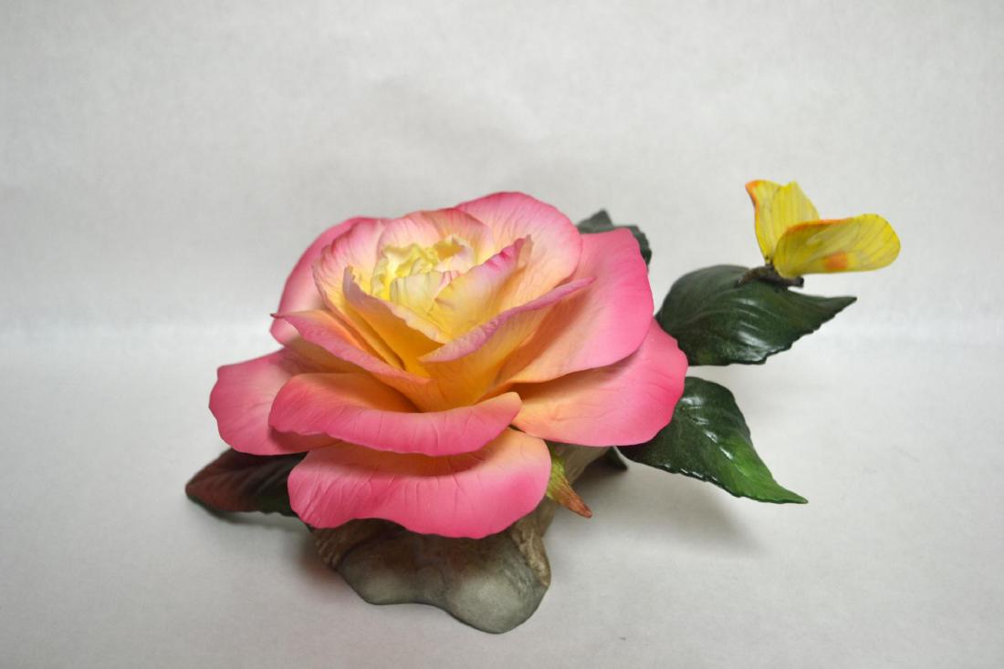 BOEHM FRENCH PARFUM ROSE WITH BUTTERFLY: Bisque Porcelain Decorated. Pink Rose on green foliage. Hallmark: F449. Dimensions: 5" H x 9"W x 6" D. Manufacturer: Boehm Country of Origin: USA