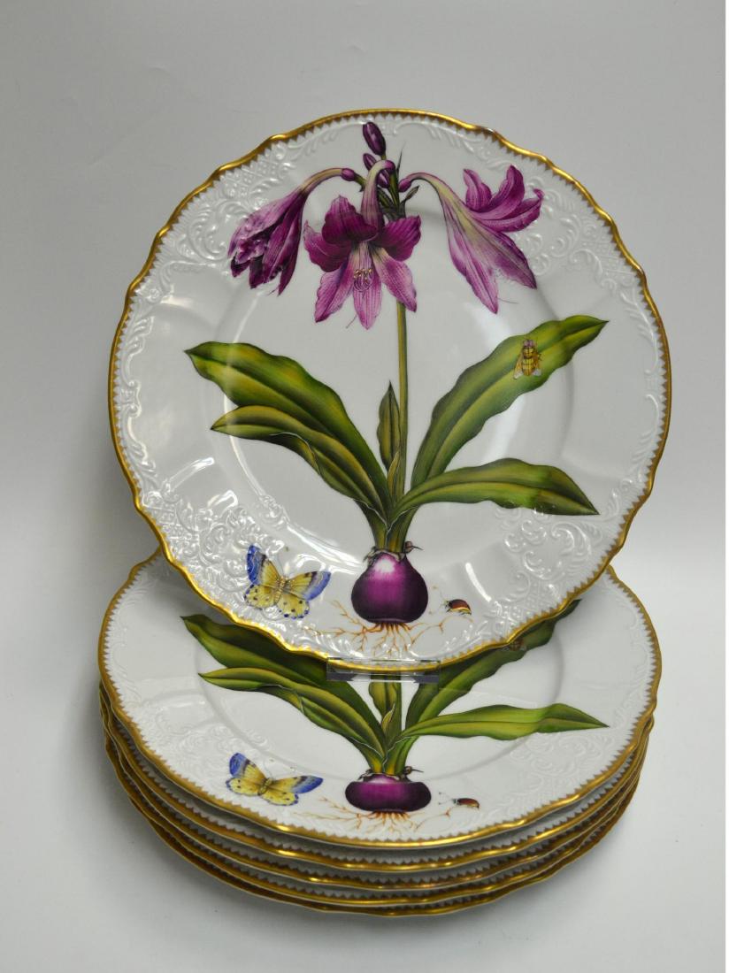 ANNE WEATHERLEY CHINA PLATES (6): Botanical Plates. Hand-painted in Hungary. White Background botanicals in purple, with gold trim. Butterfly in pattern. Fine Bone China. Each with gold trim. Issued: 2003 Dimensions: 10 1/2" Dia. Manu
