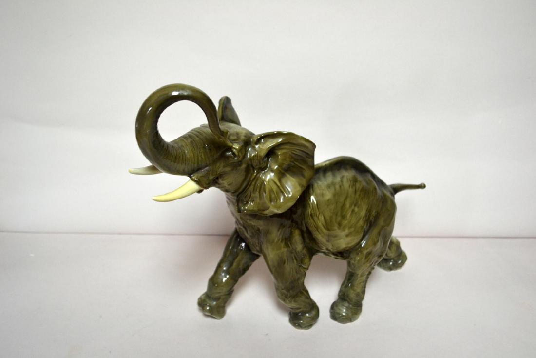 HUTSCHENREUTHER PORCELAIN ELEPHANT: Glazed Porcelain Decorated. Trunk up. Germany. Hallmark on foot. Dimensions: 12" H x 14" W x 5 1/2" D Manufacturer: Heutheruther Country of Origin: Germany