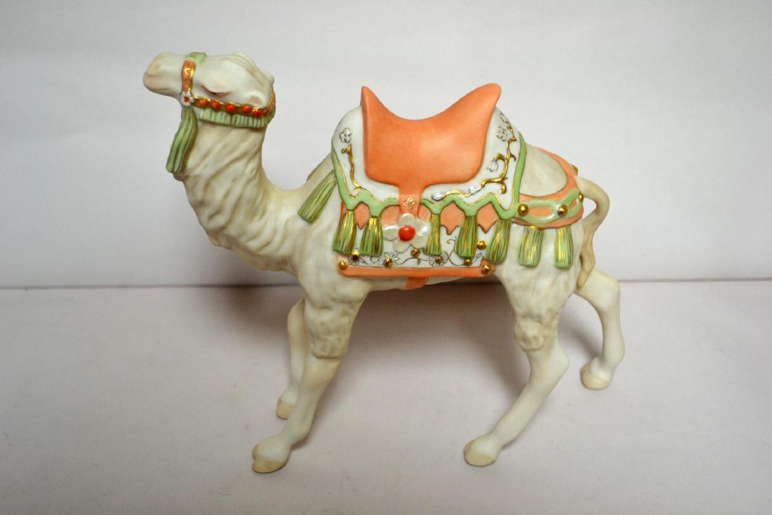 CYBIS PORCELAIN CAMEL, STANDING: Bisque Porcelain Decorated, Color Edition with Gold Embellishment. 1989, to Commemorate the Cybis 50th Anniversary. signed Cybis. Issued: 1989 Dimensions: 12 1/4" H x 3 1/4" W x 4" D Manufacturer: Cyb