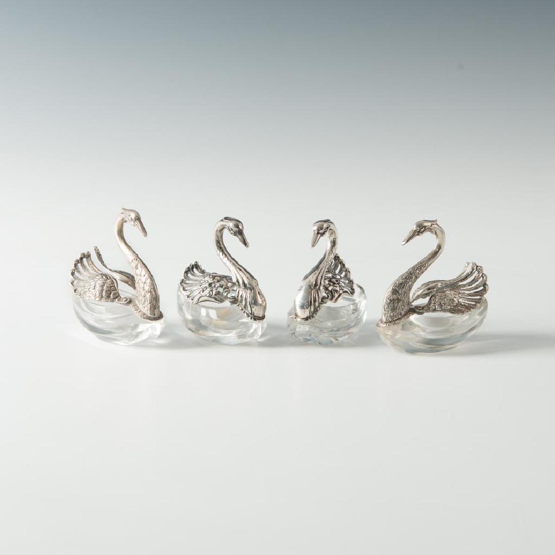 PEWTER, CRYSTAL WINGED GEESE SALTS WITH SPREADING WINGS: Two differing pairs of matched salts- wings hinge to reveal salt. Edwardian silver theme comdiment dishes that feature a clevel swing-wing design and handsome filigreed molding. Dimensions: 3"W X 3"H