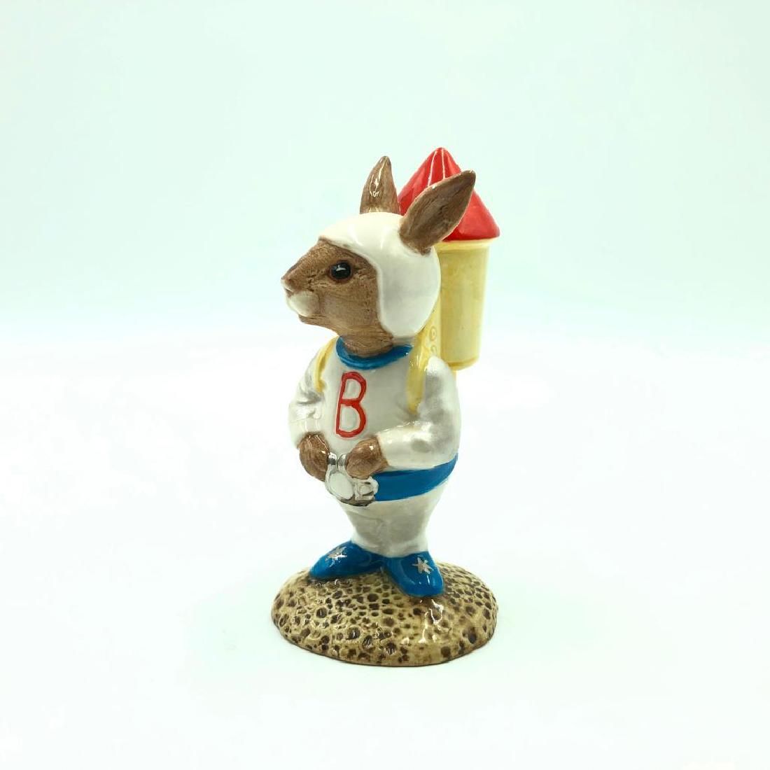 ROYAL DOULTON ASTRO BUNNYKINS ROCKET MAN DB20: Bunny dressed as a rocket man carrying a rocket on his back. Hand painted white, red, blue and yellow. Artist: Harry Sales and David Lyttleton Issued: 1983-1988 Dimensions: 4.25" Manufacturer: Royal D