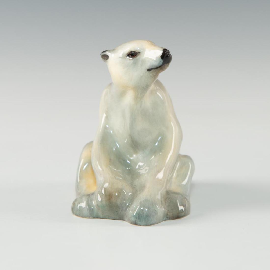 POLAR BEAR, SEATED (HN121) BY ROYAL DOULTON: A gray on white china bear, lugubriously sat upon haunches. A rarer piece, released in series from only 1912 to 1936, with gray and white colourway over china. Exquisite detail in eyes and face give g