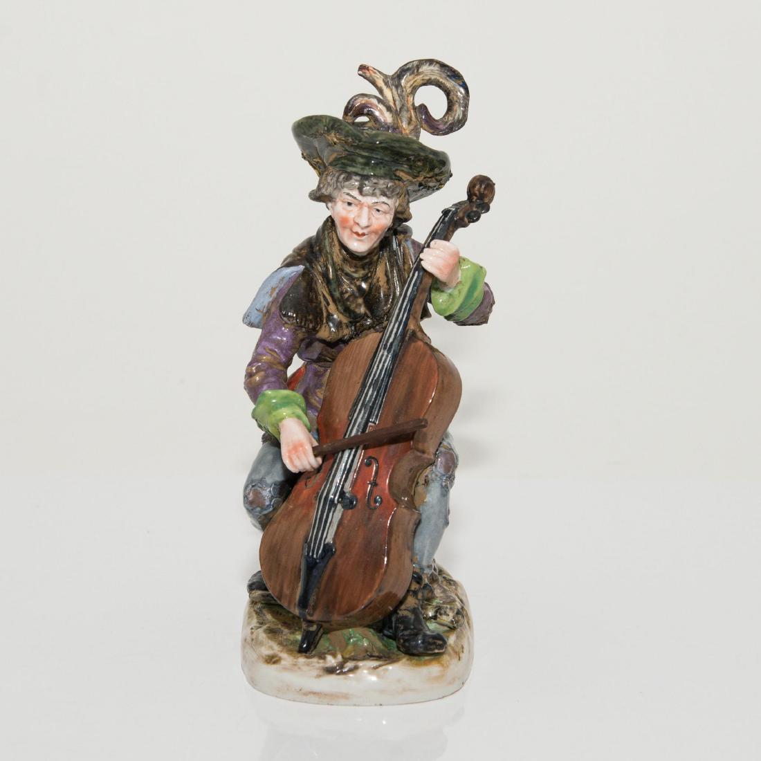 ANTIQUE CAPODIMONTE PORCELAIN FIGURINE MUSICIAN: Capodimonte Figure of a Man Playing Cello. Issued: Circa late 19th / early 20th century Dimensions: 8.25"H x 5"L x 3.5"W Country of Origin: Italy
