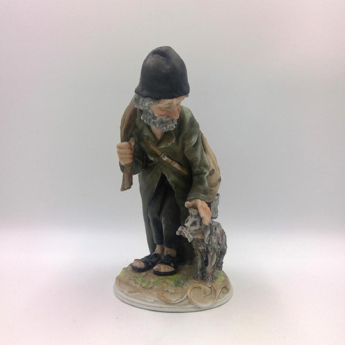 VINTAGE ITALIAN PORCELAIN FIGURINE MAN WITH DOG: Vintage Capodimonte Style Figurine of an Elderly Man with a Dog. Marked on the bottom. Artist: Antonio Benni Issued: circa 1960s Dimensions: 8.5"H x 5.5"L x 4.5"W Country of Origin: Italy
