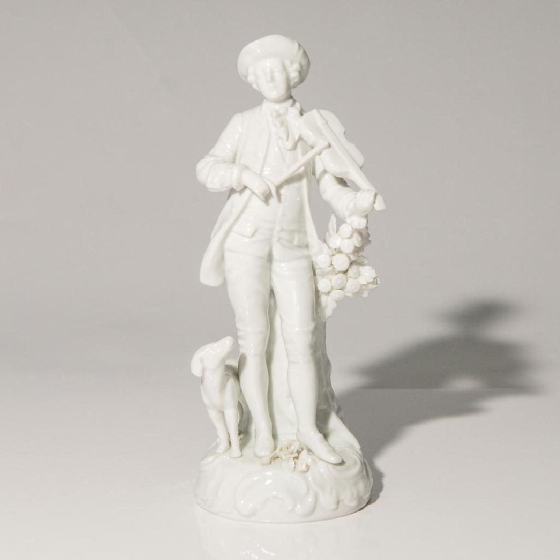 SITZENDORF GERMAN PORCELAIN FIGURINE MUSICIAN: Sitzendorf Blanc de Chine Figurine of a Man Playing Violin and his Dog Standing nearby. Issued: circa 1920s Dimensions: 9.5"H x 3.5"D Country of Origin: Germany