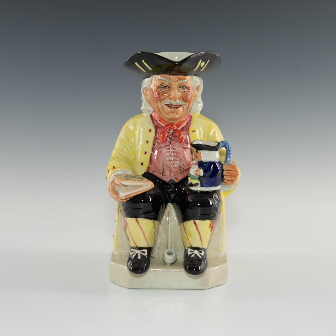 KEVIN FRANCIS VIC SCHULER TOBY JUG YELLOW JACKET: Depicts author of Collecting British Toby Jugs, holding book, jug Limited edition piece. Issued: 1988 Dimensions: 8.75"H Edition Size: 1000 Edition Number: 490 Manufacturer: Prestige Jugs Country