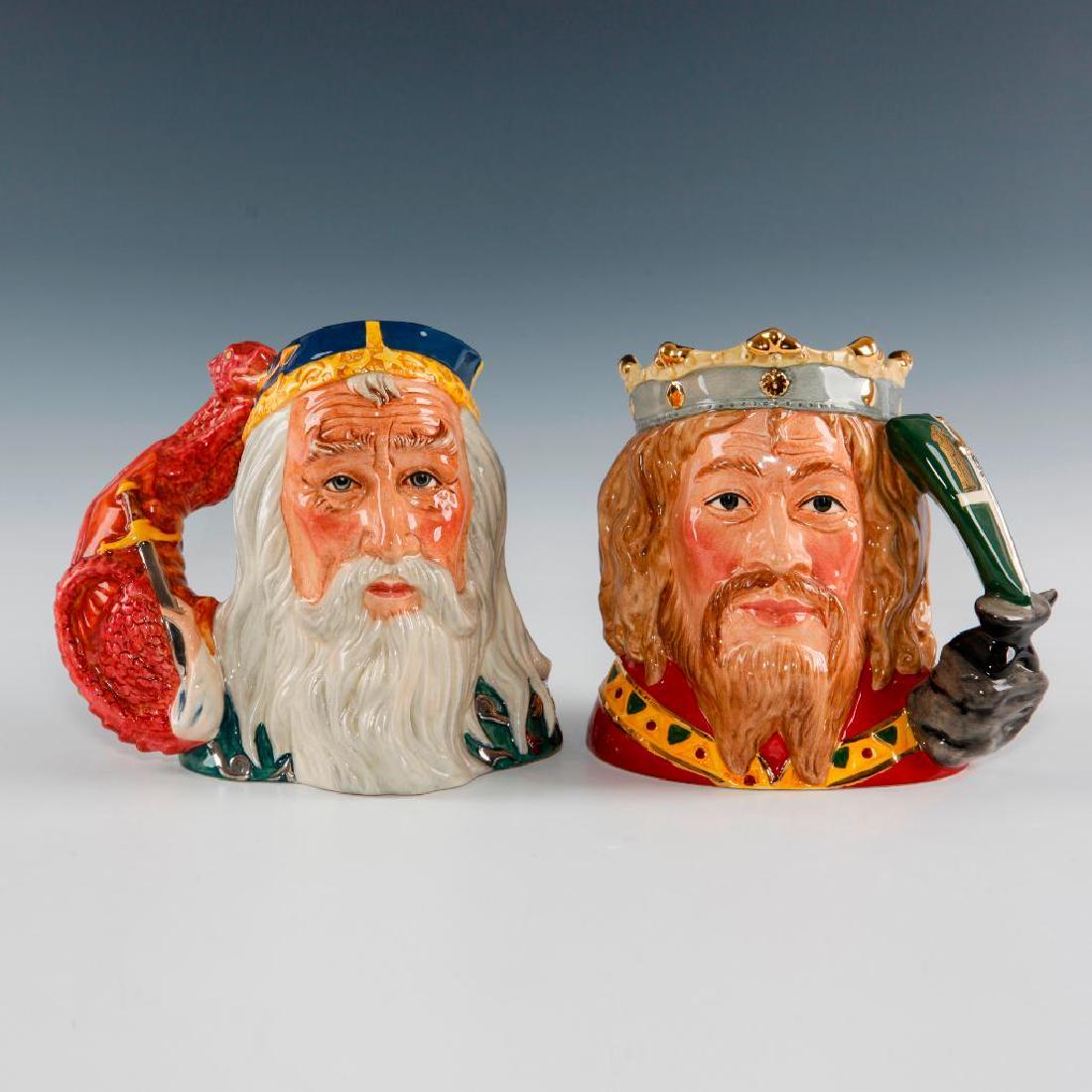 ROYAL DOULTON KING ARTHUR & MERLIN LARGE JUGS: Large character jugs D7055 and D7117. In 1998 the King Arthur jug was followed with second version Merlin jug with a dragon and sword handle, making a pair. Artist: Robert Tabbenor Issued: c. 1990 Dim