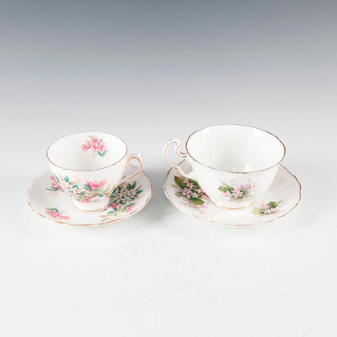GROUP OF 4pc ENGLISH PORCELAIN CUPS AND SAUCERS: Two pairs of tea cup and saucer. Royal Adderley Mayflower 1323 pattern and Royal Vale pattern 7672. Finely painted with flowers, gilded ruffled rims. Dimensions: Largest cup is 4.25"D 2.75"H, saucer 6