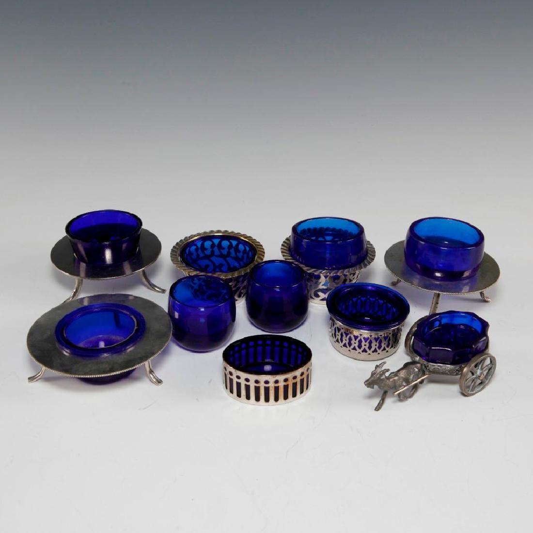 LOT OF 10 GEORGIAN STYLED PEWTER AND PLATE OPEN SALTS: Petite table salts, includes a matched pair, 2 cobalt blue glass. An array in of vintage salts, many in the Georgian style, pewter goat pulling his wagon, and several marked- one saucer platform is st