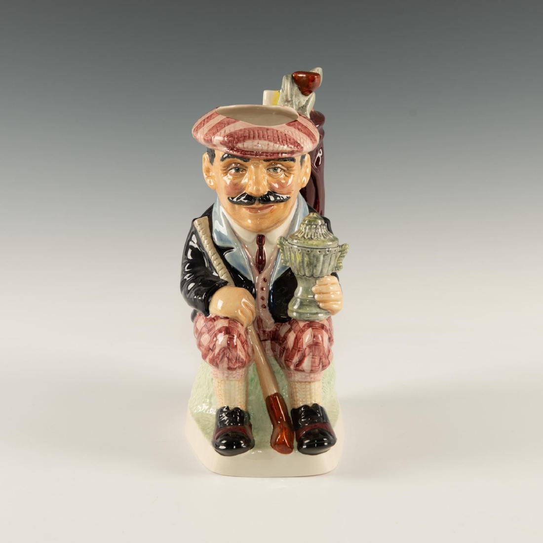 KEVIN FRANCIS THE GARDENER TOBY JUG BURGUNDY WAISTCOAT: Dark beard, blue pants. Holds giant gourd and 1st prize cup. Limited edition piece. Issued: c. 1995 Dimensions: 8.5"H Edition Size: 1500 Edition Number: 103 Manufacturer: Kevin Francis Ceramics C