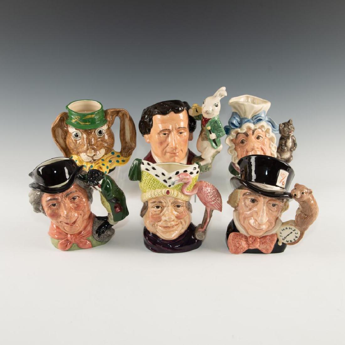 SET OF 6 ROYAL DOULTON ALICE IN WONDERLAND JUGS: Jug depicts characters from British novel Alice in Wonderland. Includes Lewis Carroll D7996, March Hare D6776, Cook & Cheshire Cat D6842, Mad Hatter D6598, Walrus and Carpenter D6600, and Ugly Duchess