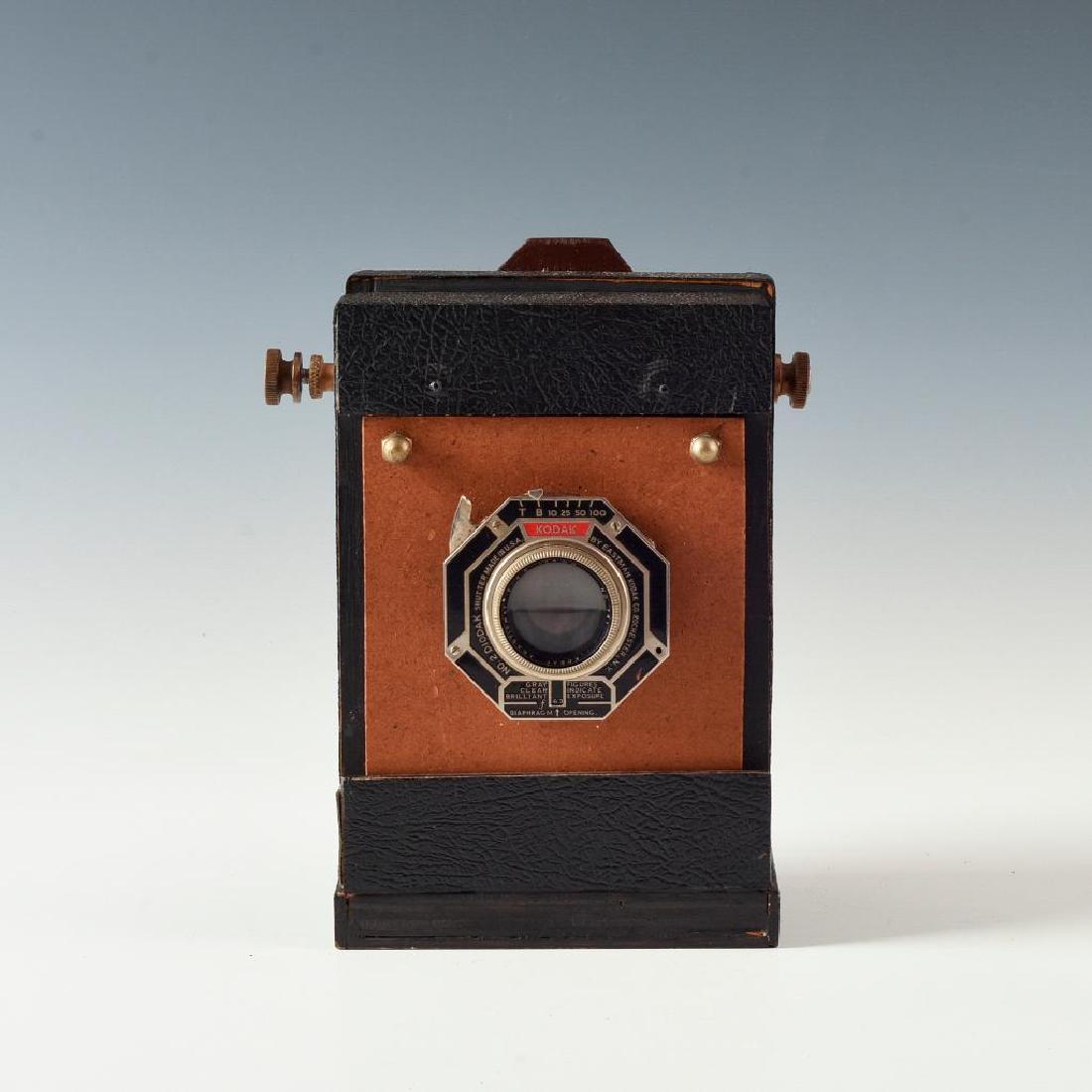 HANDMADE WOODEN SHEETFILM BELLOWS CAMERA: Compact folding Large Format camera with Kodak shutter. Intact ground glass element and trippable shutter folds out to accept plate/sheet holders. Dimensions: 4.5"L X 4"D X 7"H
