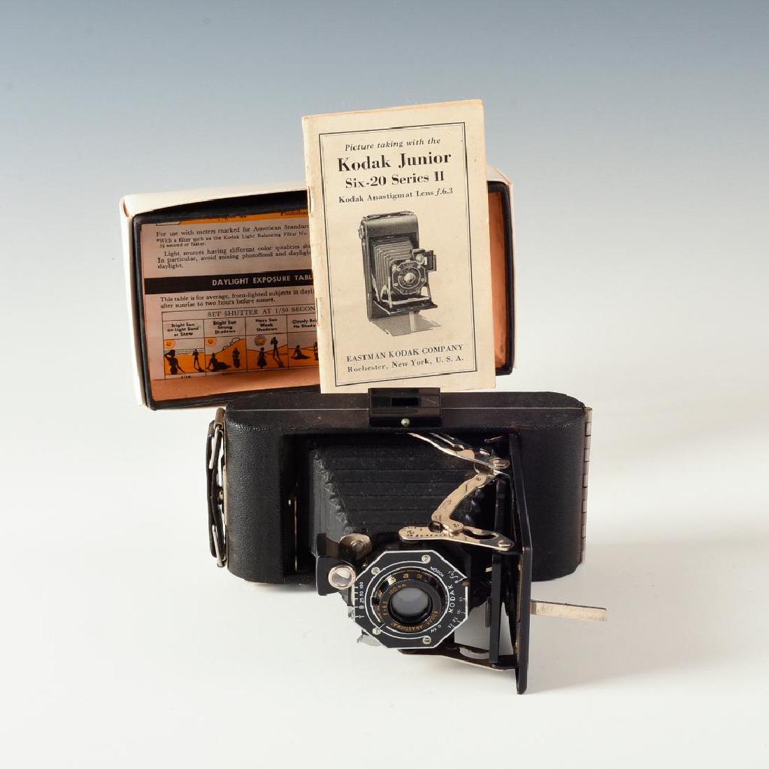 BOXED KODAK JUNIOR SIX-20 SERIES II BELLOWS CAMERA: Antique Kodak with Anastigmat 6.3 F100mm lens, manual, box. Issued: 1910's Dimensions: 7"L X 3.5"D X 2"H in box Manufacturer: Kodak Country of Origin: United States