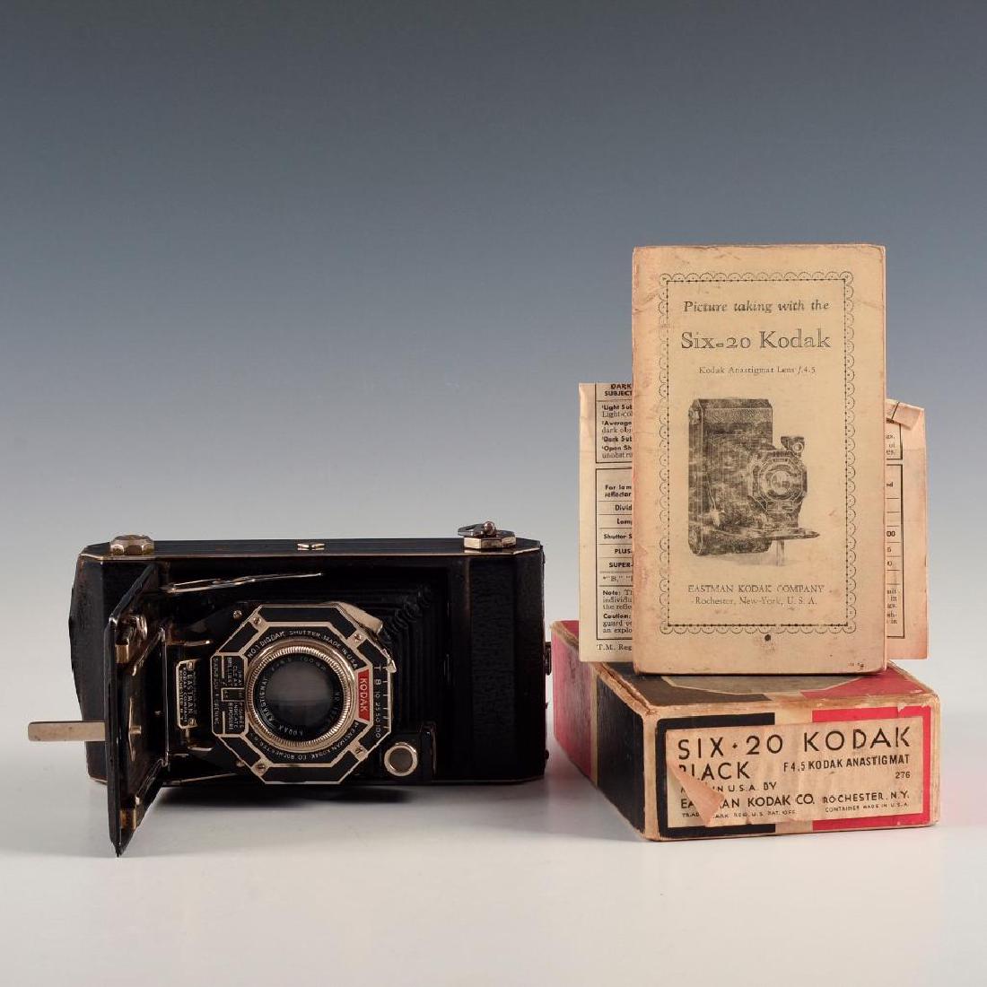 ANTIQUE KODAK SIX-20 FOLDING CAMERA IN BOX WITH MANUAL: Bellows medium format camera with F4.5 Anastigmat lens. Dimensions: 6.5"L X 3.5"D X 1.5"H in box Manufacturer: Kodak Country of Origin: United States