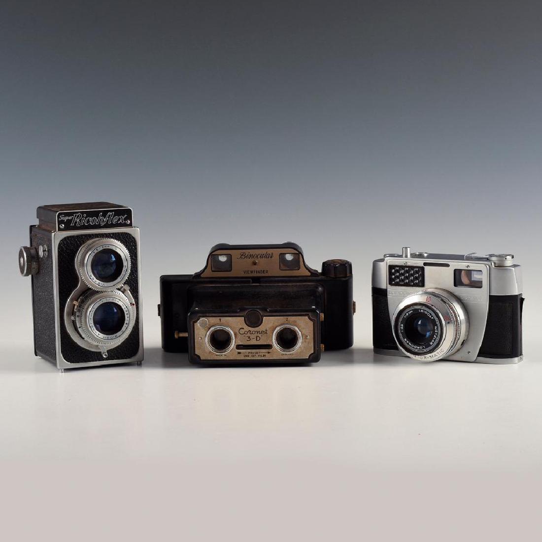 TRIO OF CLASSIC DESIGN CAMERAS FOR DESK OR MANTLE: Quirky stereo 3D, chromed German 35mm, industrial chic Ricohflex. Dimensions: 3"L X 4"D X 7.5"H largest Manufacturer: Various Country of Origin: Various