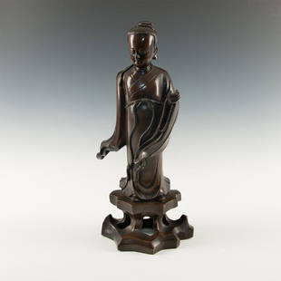 CHINESE MING DYNASTY BRONZE IMMORTAL GUANYIN SCULPTURE: Dark bronze made with superb casting and evincing a rich brown antique patina. Modeled as Guanyin, the Chinese Immortal of mercy and compassion, with her hand raised in blessing. Ming Dynasty (1368 16