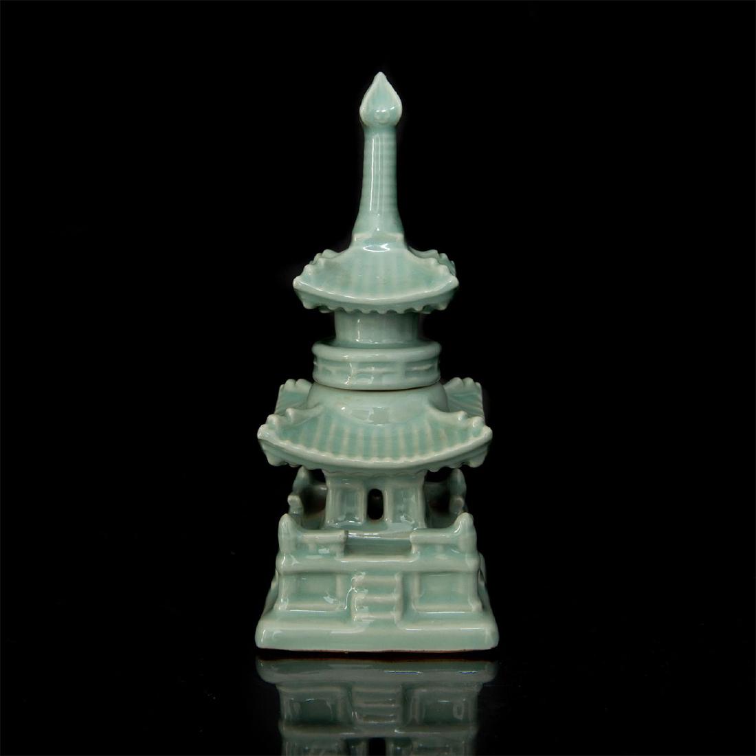 JAPANESE CELADON GLAZED TWO-PIECE PAGODA CENSER: Rich green classical glaze over multi-story pagoda shape, with removable top. Marked on bottom with Japanese impress. Dimensions: 8.5"H X 3.5"D Provenance: Alan Setain Country of Origin: China