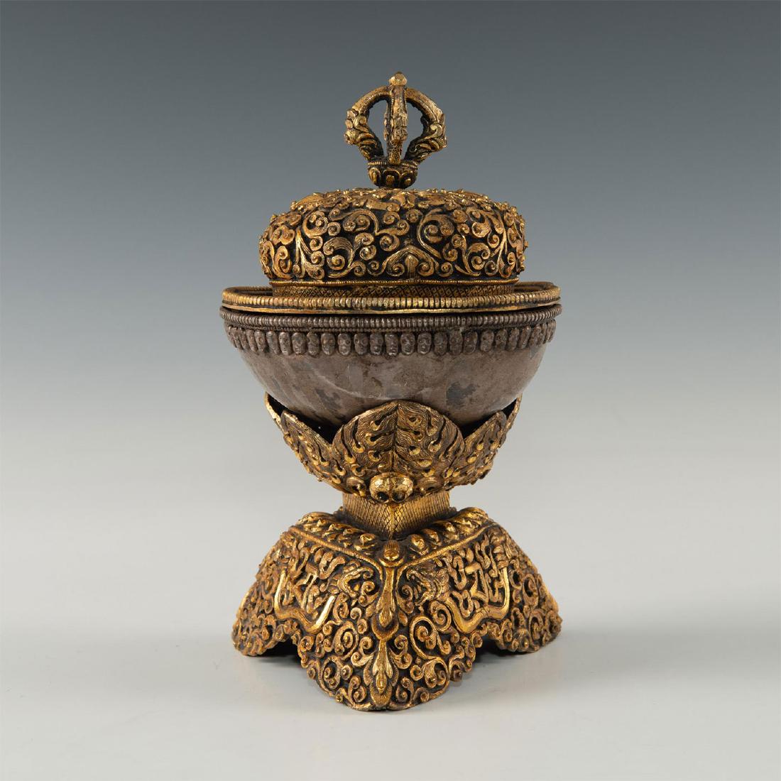 GILT SILVER CHINESE TIBETAN BUDDHIST KAPALA: Unique 3-tier design with fine engraving and etched faces around the rim. Dimensions: 4.5"L X 4.'5"D X 7.5"H Country of Origin: TIBET