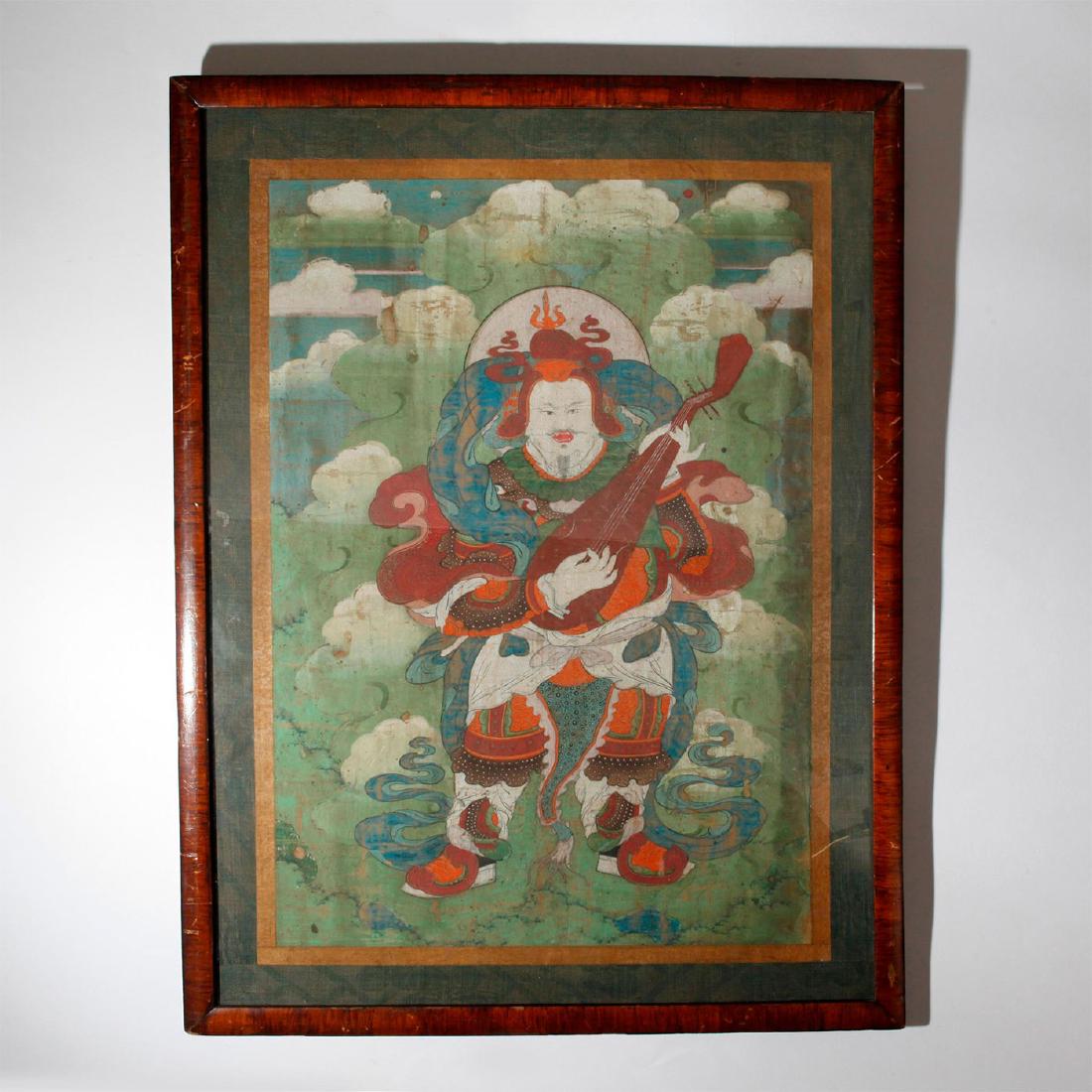 CHINESE SINO-TIBETAN THANGKA OIL PAINT ON SILK, FRAMED: Large central Chinese divinity figure playing a stringed Pipa. Bordered with gilt, wooden frame. A Thangka, Sino Tibetan Buddhist oil painting on silk depicting a Chinese Buddhist deity. Large central