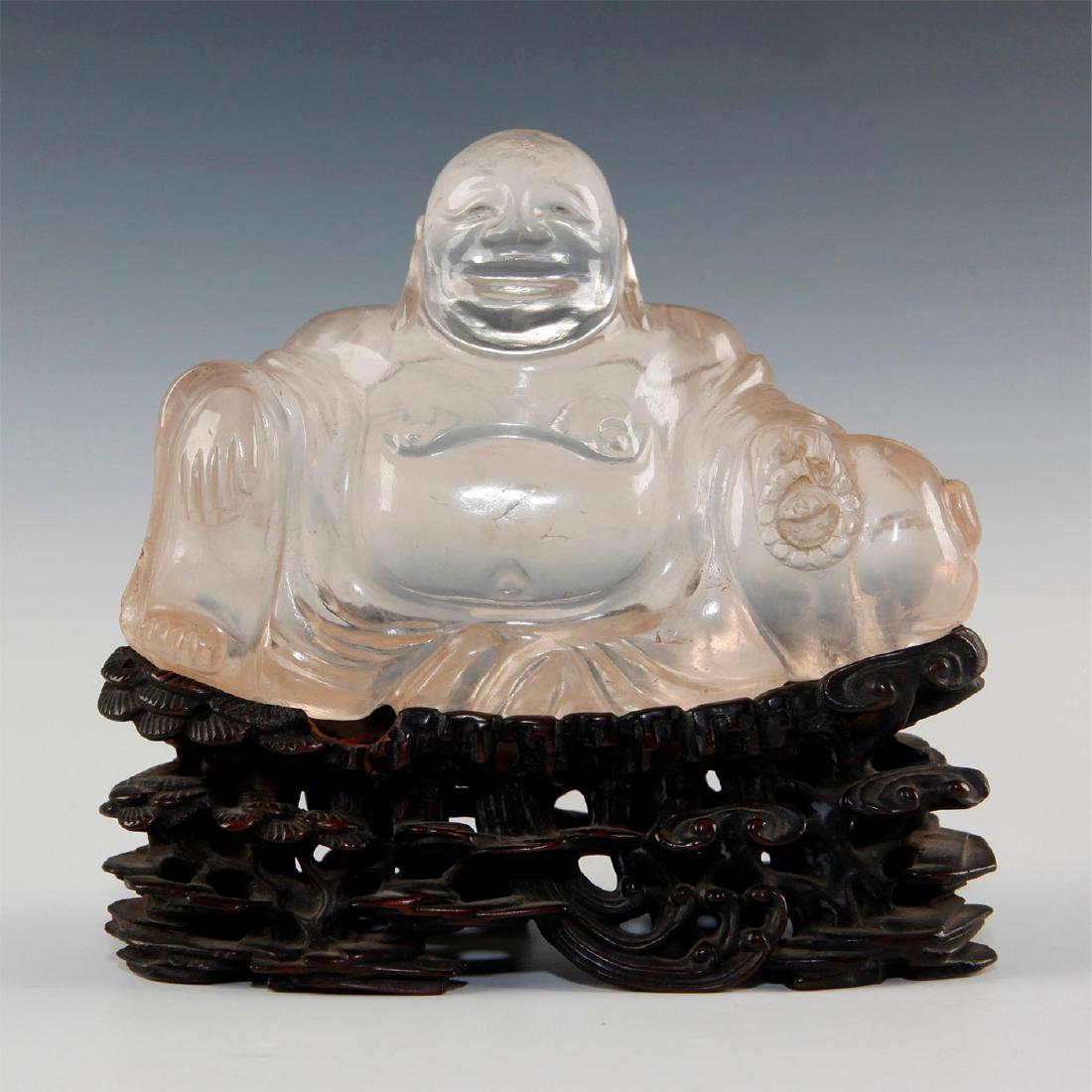 CARVED ROCK CRYSTAL BUDDHA ON STAND: Figural carving in natural crystal. Linghzi mushrooms carved into complex figural patterns. Issued: 19th/20th c. Dimensions: 5"L X 2.25"D X 5"H Country of Origin: China