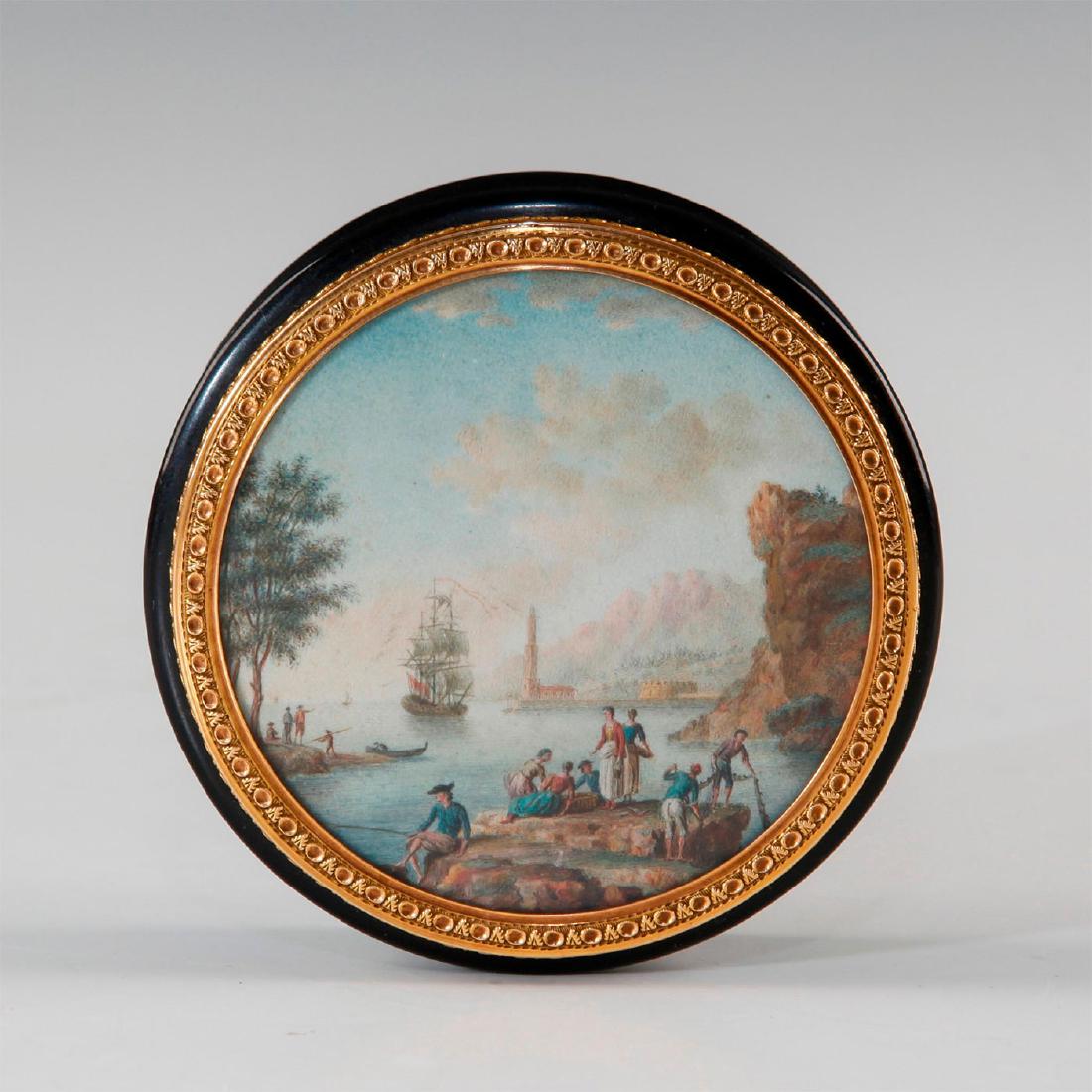 18TH CENTURY CAREY BOX WITH GOLD TRIM, PAINTED SCENE: Chased gold trim around a brilliant scene of bayside activity, a'fore a tall ship. Interior is also gold, hallmarked. Issued: 18th c. Dimensions: 3.25"D X 0.75"H Country of Origin: European