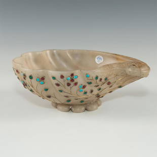 JADE MUGHAL STYLE BEJEWELED DISH SHELL SHAPE FLOWER: Jade carved dish with wire formed jewel leaves on underside in multicolor enamel. Created in India or Persia. Dimensions: 7.5"L X 5.75"D X 2.75"H Country of Origin: India / Persia / China