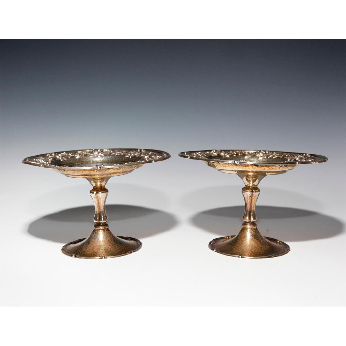 PAIR OF EDWARDIAN FIRE GILDED STERLING SILVER COMPOTES: Fine rose-vine repousse, relief molding and hand-hammered decoration. London hallmarks. Approximate total sterling weight, 25.7 Troy. Issued: 1909 Dimensions: 7.25"D X 4.5"H Country of Origin: England