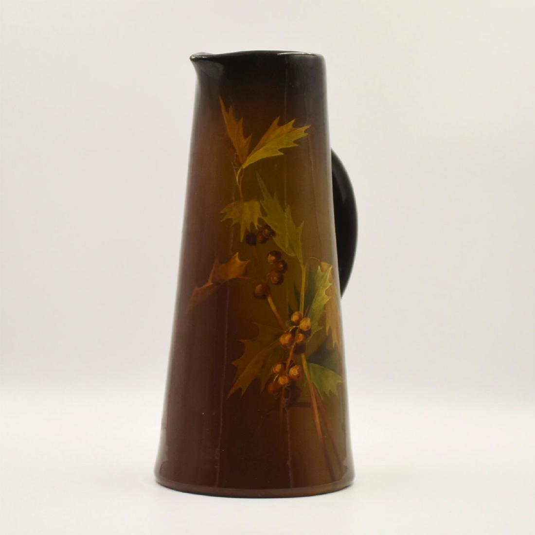 WELLER LOUWELSA GLAZED EARTHENWARE PITCHER OAKLEAVES: A glazed dark brown and russet earthenware pitcher with floral decorations of oakleaves and acorns in relief, impressed marks to base LOUWELSA WELLER used c. 1896, other marks. Issued: c. 1896 Dimensi