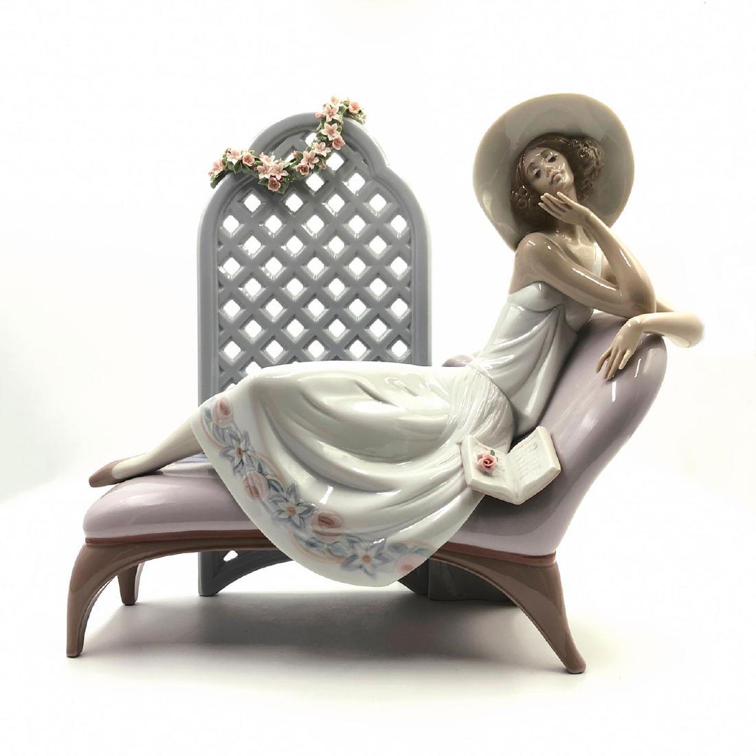 LLADRO FIGURINE GARDEN DREAMS: Lady in chair with book - Lladro number 01007634. Poemas de Amor Artist: Jose Puche Issued: 1994 Dimensions: H-12.50" Manufacturer: Lladro Country of Origin: Spain