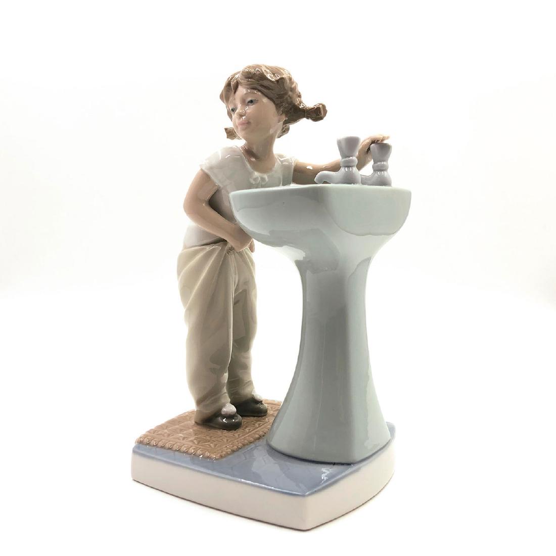 LLADRO FIGURINE CLEAN UP TIME: Girl in front of a sink wearing pajamas - Lladro number 01004838. LA NINA DEL LAVAMOS Artist: Julio Fernandez Issued: 1973 Dimensions: 7.5"H Manufacturer: Lladro Country of Origin: Spain