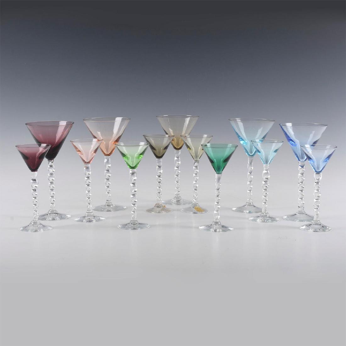 COLORED MARTINI AND CORDIAL GLASSES: 13 Pieces of Colored twisted stem glasses in two sizes Five Martini glasses and Eight cordial glasses. All with twisted stems and in different colors. Dimensions: 6 3/ 4"Martini, 5 1 /2"Cordial