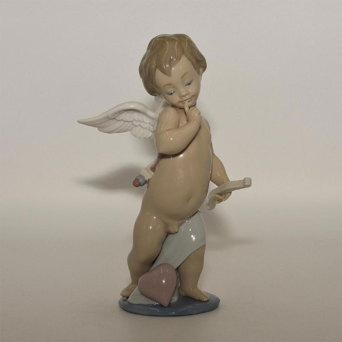 LLADRO FIGURINE CUPID TYPE 383: Cupid carrying his arrow - Lladro number 01006311. FLECHA DE AMOR (with box). Artist: Jose Puche Issued: 1996 Dimensions: 6.45"H Manufacturer: Lladro Country of Origin: Spain